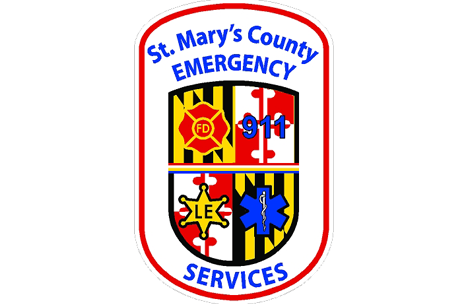 The Emergency Services logo - symbols for fire, 911, law enforcement, and ems services on top of a shield with the four quadrants of the Maryland flag. Reads 'St. Mary's County Emergency Services'.