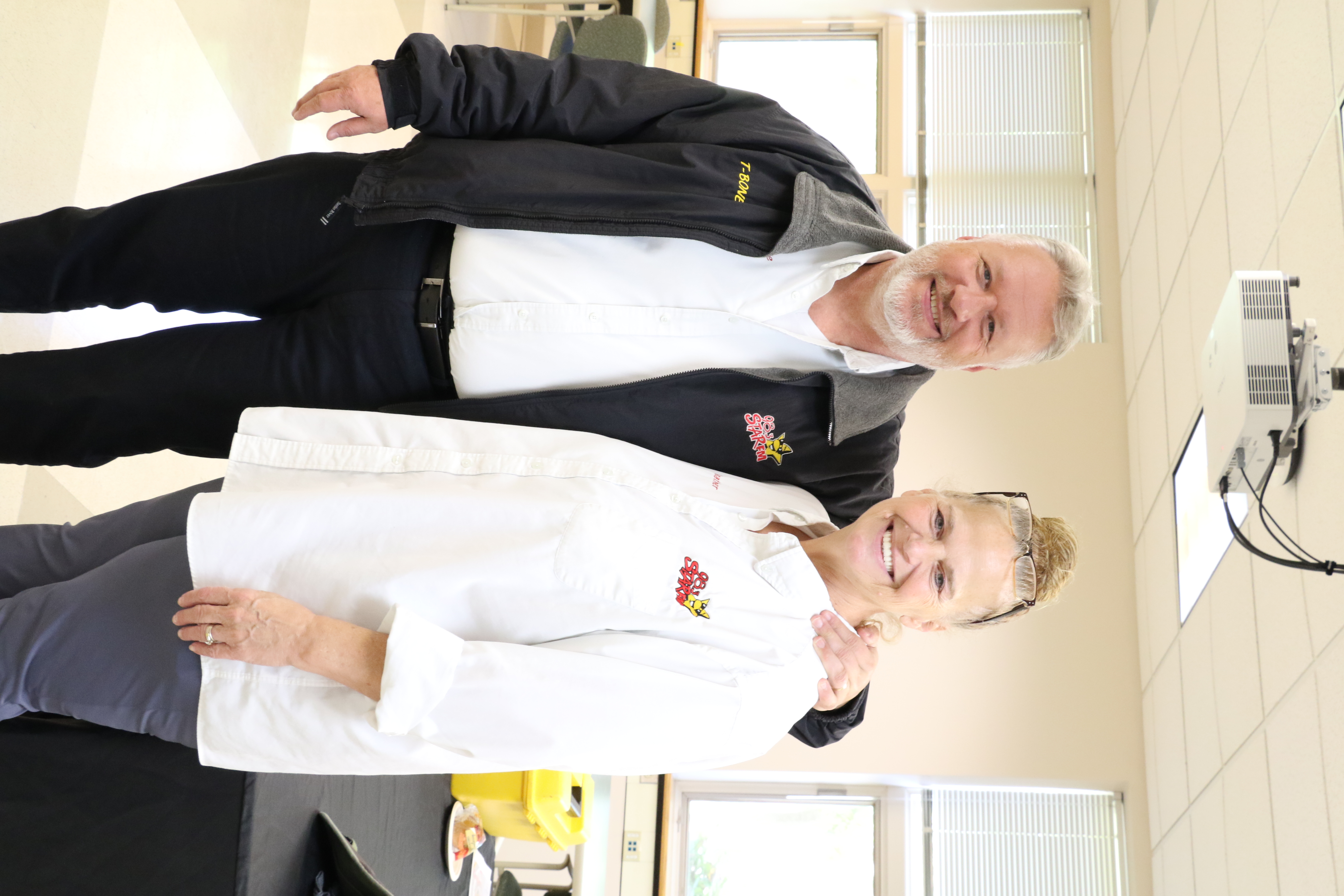 Two people taking a photo together in a classroom environment